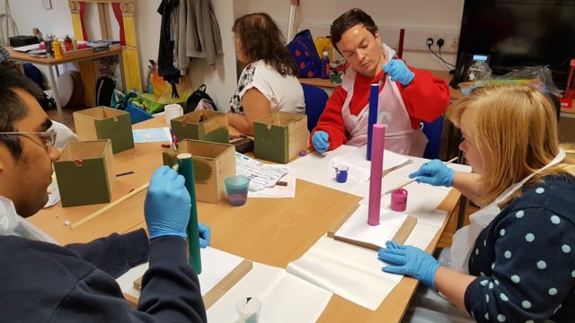 Day Service members painting craft pieces