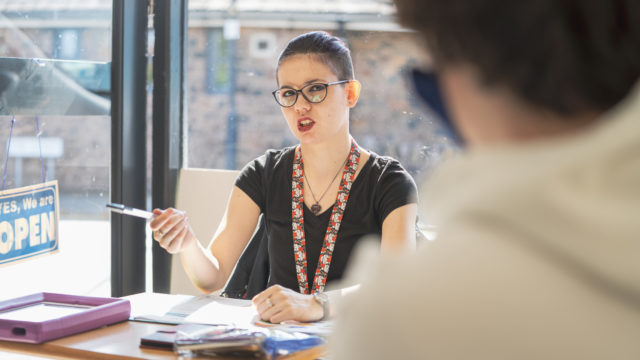 Student talking with classmates in a session