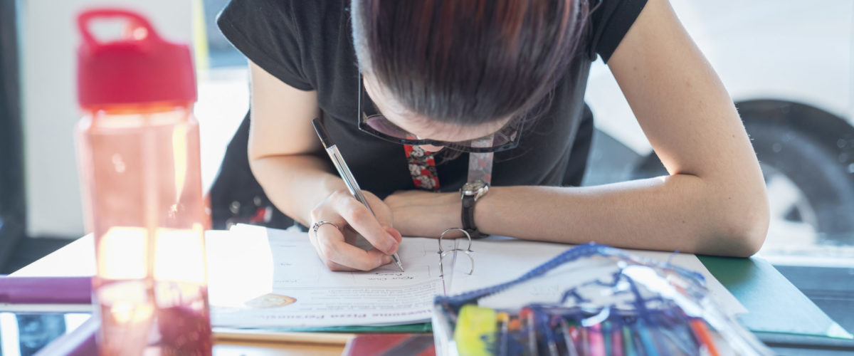 Student concentrating on filling in their worksheet