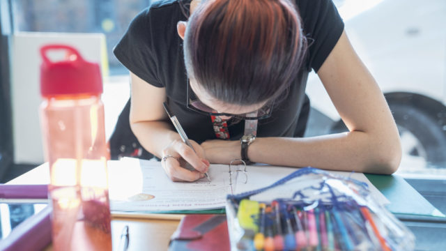 Student concentrating on filling in their worksheet