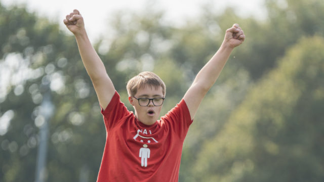 Student cheering with arms in the air