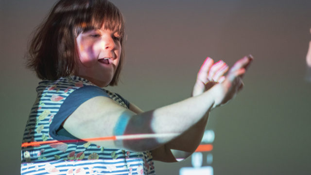 Student dancing with a projection over their body