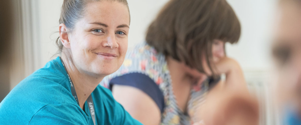 Learning Support Assistant in a session smiling at the camera