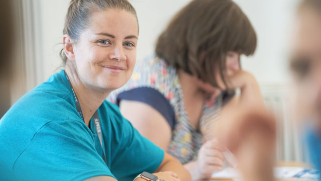 Learning Support Assistant in a session smiling at the camera