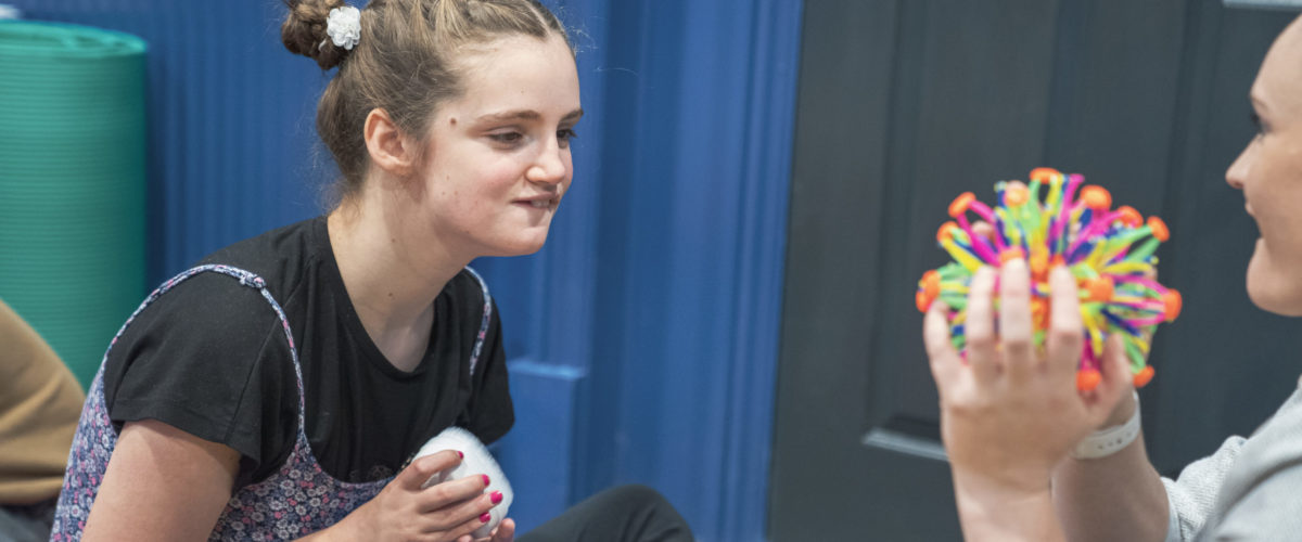 Student staring at a sensory toy