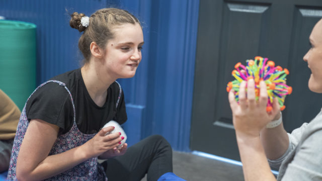 Student staring at a sensory toy