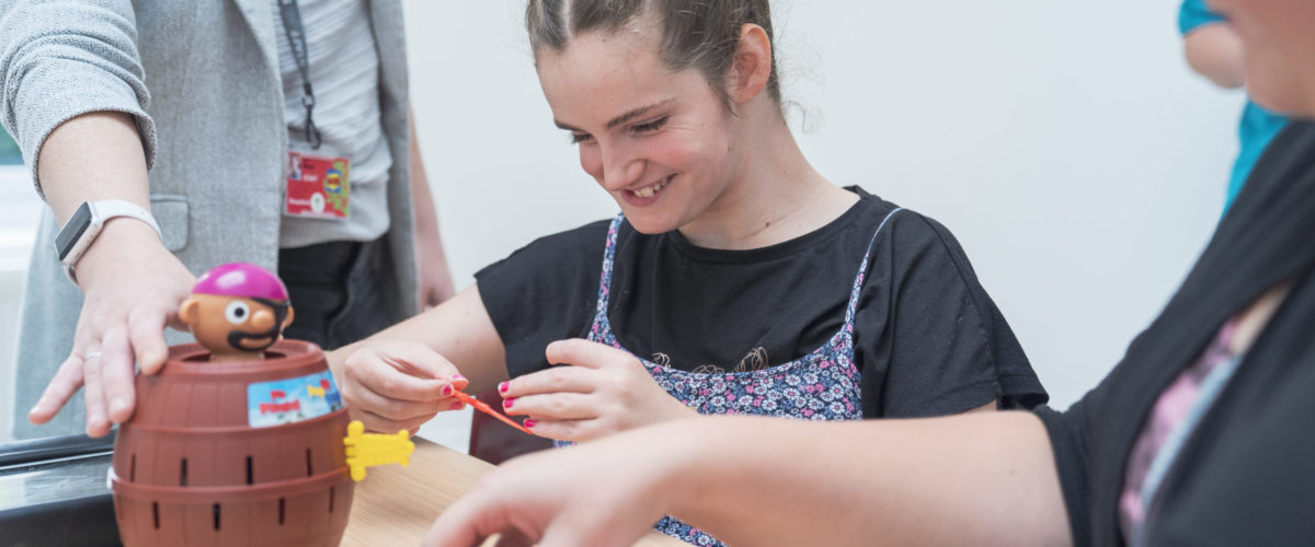 Student smiling playing a game