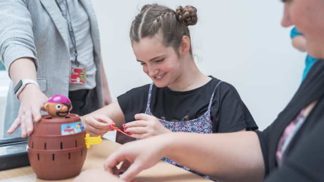 Student smiling playing a game