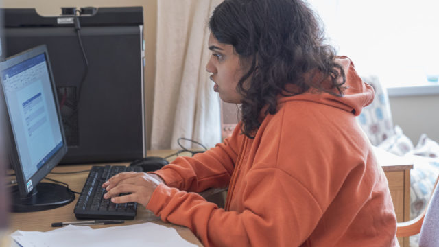 Student using the computer to complete their homework