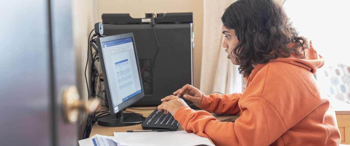 Student using the computer to complete their homework