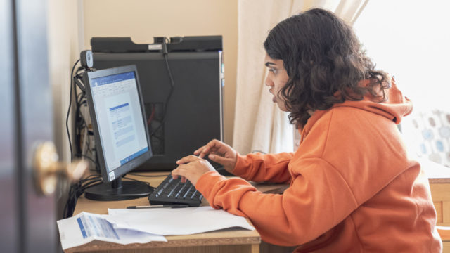 Student using the computer to complete their homework