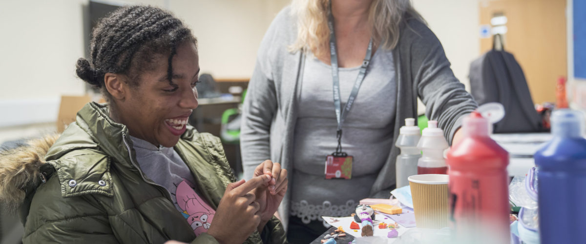 Student creating doll out of modelling clay