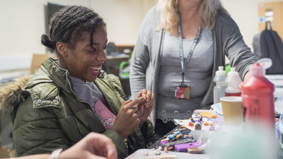 Student creating doll out of modelling clay