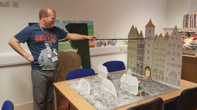 Day Service member playing with social history model