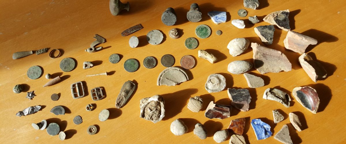 Selection of finds from metal-detecting, including coins, buckles and buttons