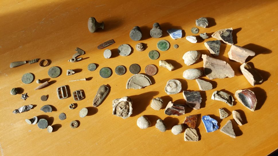 Selection of finds from metal-detecting, including coins, buckles and buttons