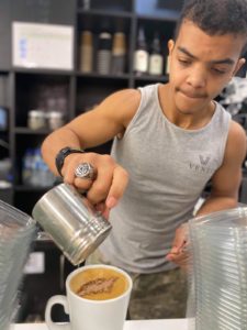 Student making coffee from freshly grinded beans