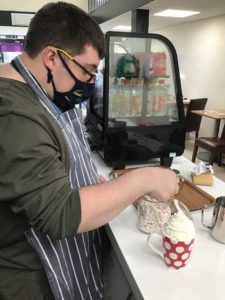 Student Jack making a hot chocolate at Breward's