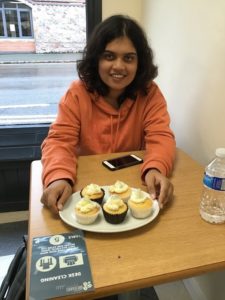 Student showing off their cupcakes