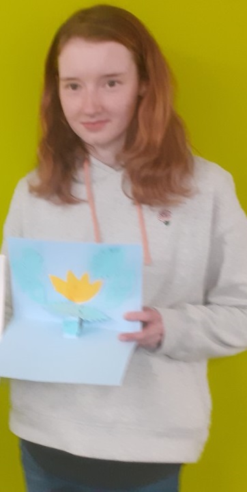 Student holding a pop-up flower card