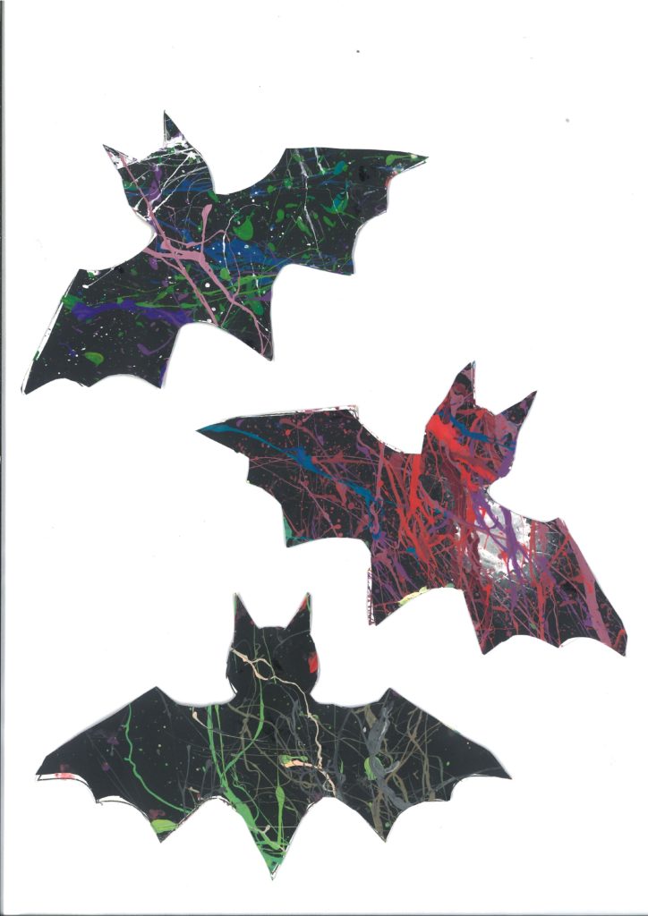 Splatter painting of three bats