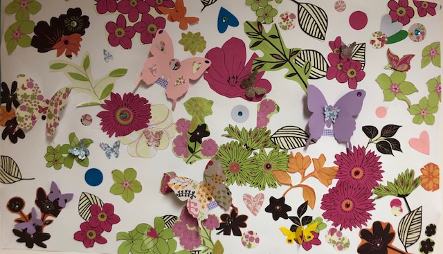 3D mural from paper and cut outs full of flowers and butterflies