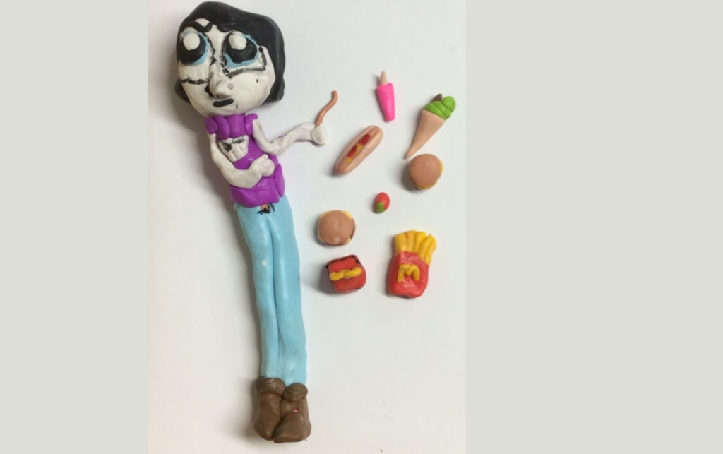 Clay character of a woman surrounded by McDonalds food items