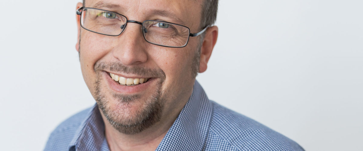 Headshot of Mark Sessions, Head of Funding & Compliance smiling at the camera