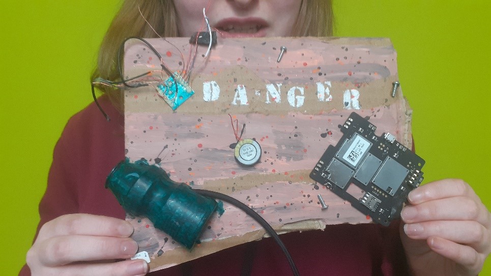Danger mixed media - floppy disk and computer parts on a background that says danger