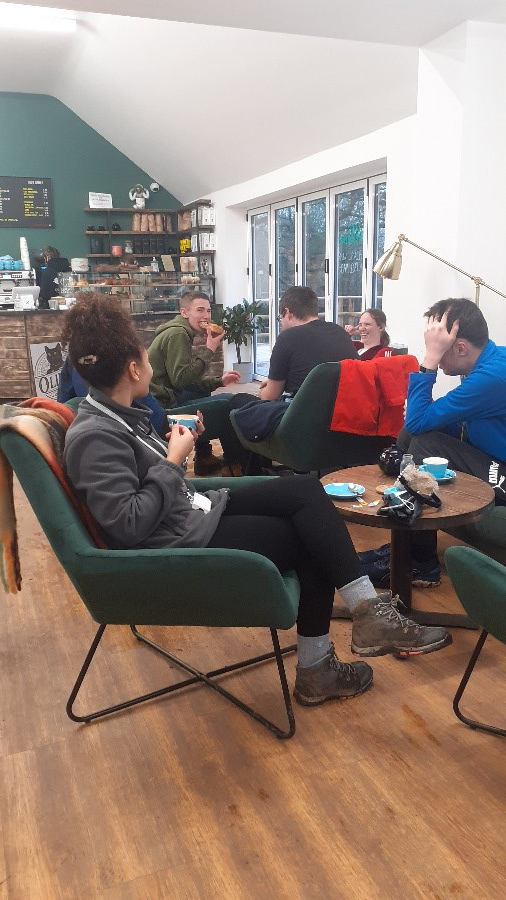 Students and staff enjoying food in a cafe