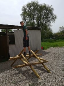 boy stood on top of wooden structure