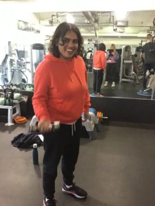 girl holding weights in gym