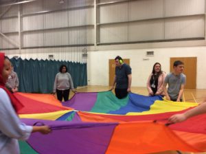 students playing with parachute