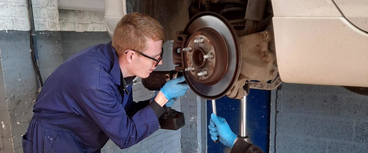 Student working on car wheel