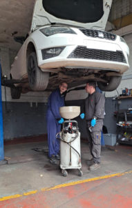 boy inspecting car