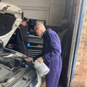 boy filling up car