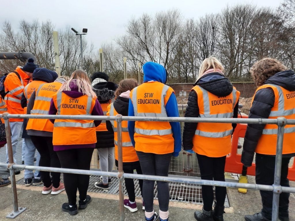 Backs of students wearing high vis jackets at Severn Trent Waters