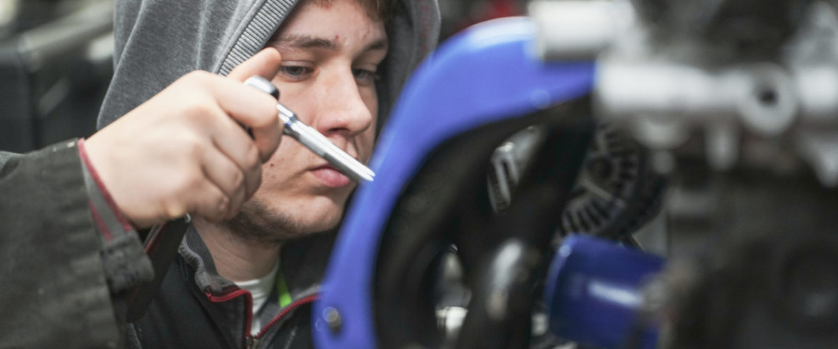 boy fixing engine