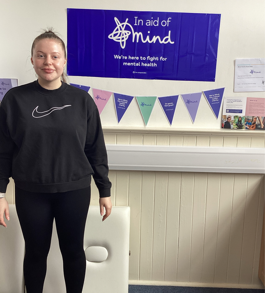 Student Chelsea standing in front of Mind bunting and banner