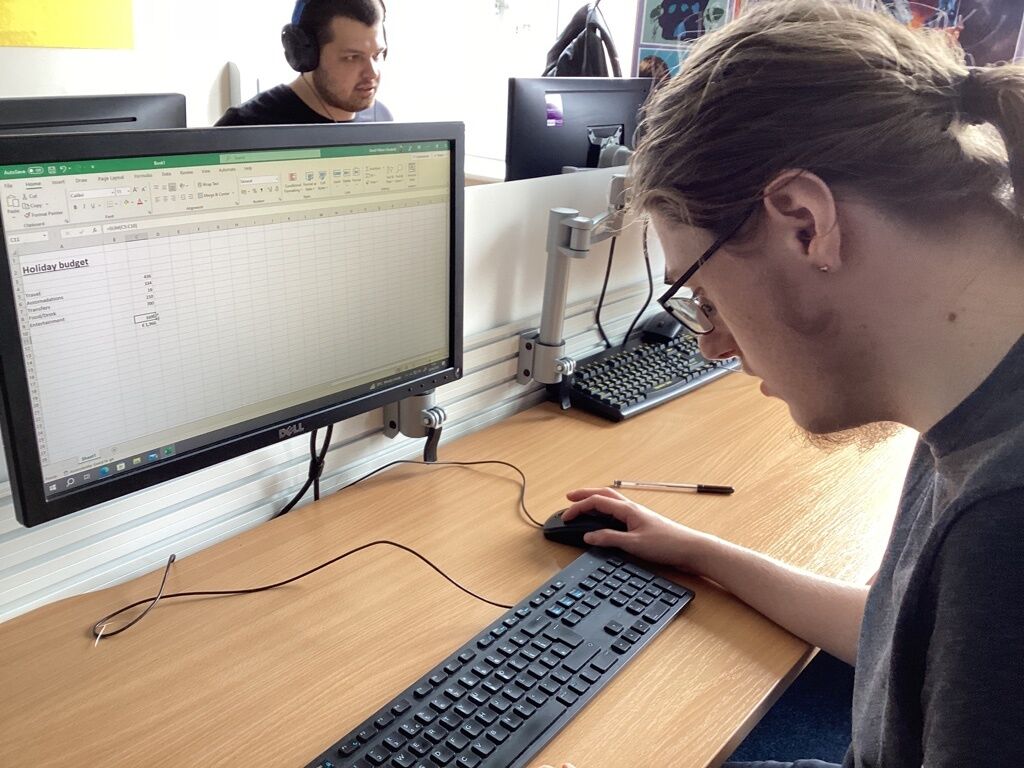 Student looking a computer keyboard