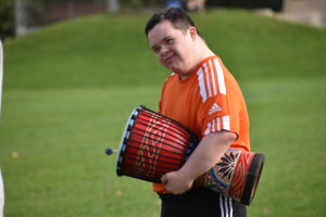 Boy playing hand-held drum