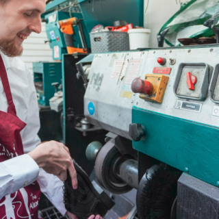Student polishing shoe at Timpson