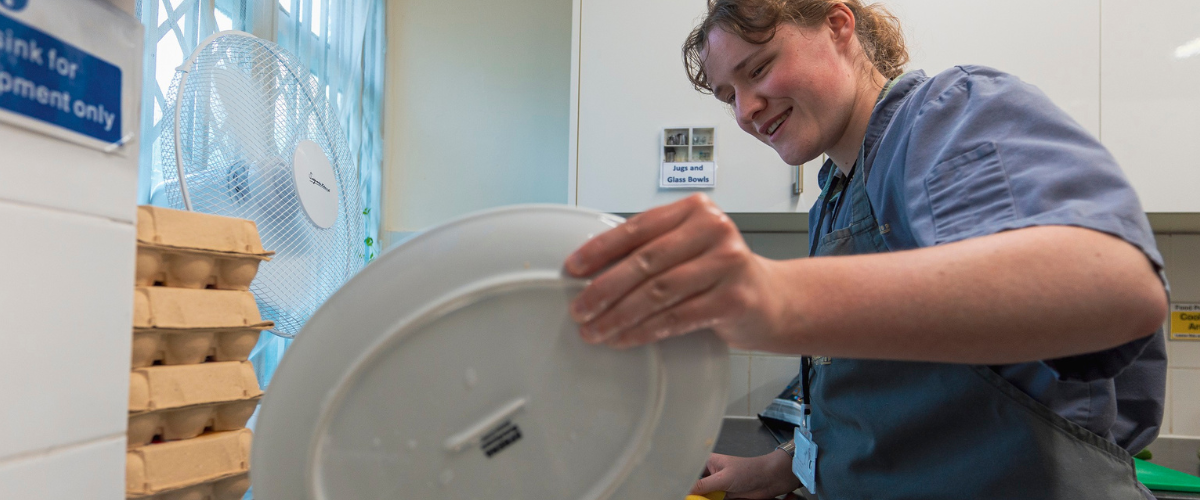 Student washing up at our catering enterprise