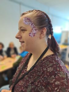 Student showing staff there glitter face paint