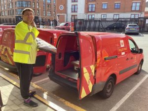 Supported Internship student loading up a Royal Mail van
