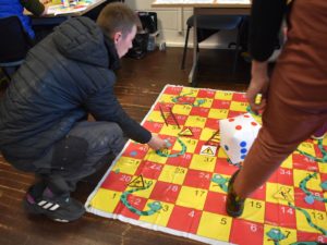 Student playing snakes and ladders