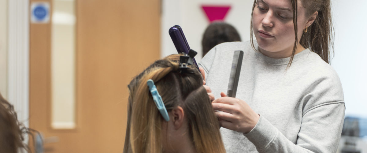 Student cutting hair