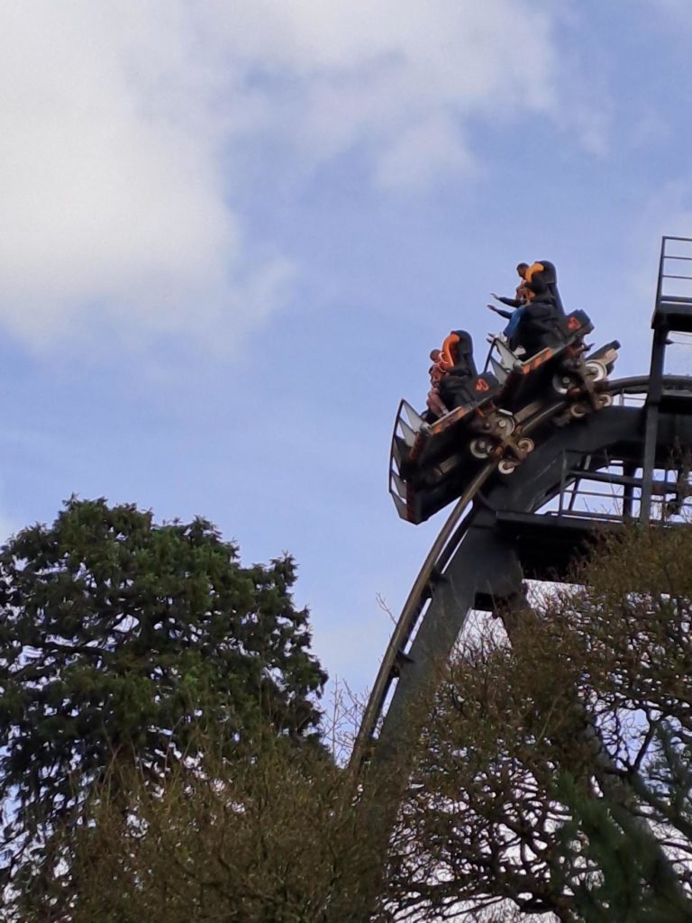 Staff member and two students on a rollercoaster