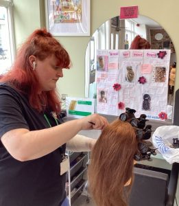 Student in salon sectioning hair