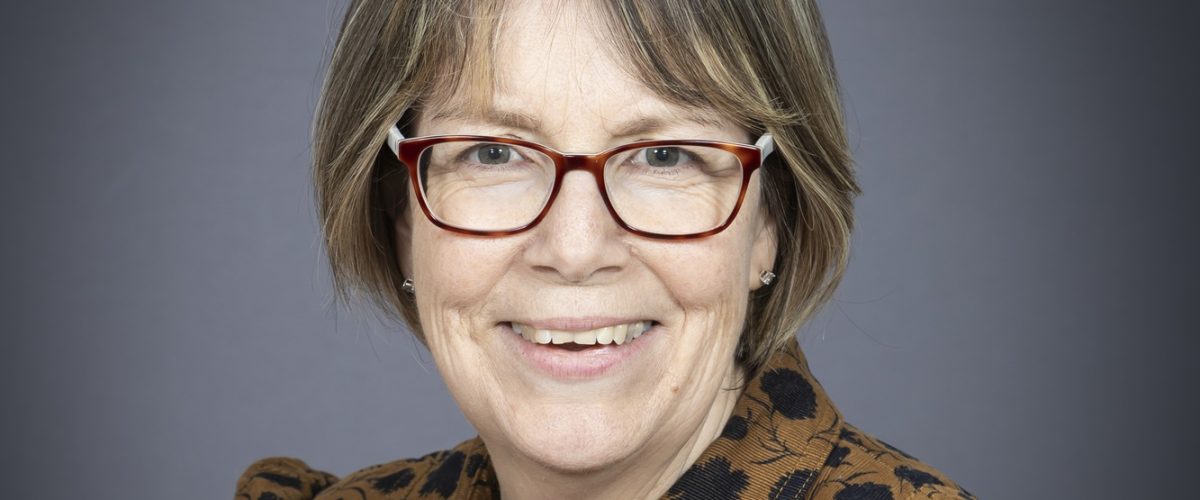 Headshot of trustee Caroline Stevens, smiling at the camera